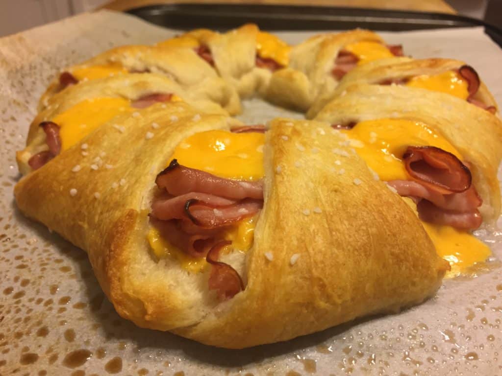 ham and cheese crescent roll ring baked on sheet pan and sprinked with pretzel salt