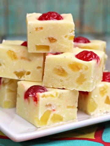 pieces of pineapple fudge stacked on white plate