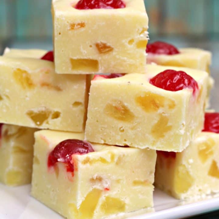pieces of pineapple fudge stacked on white plate