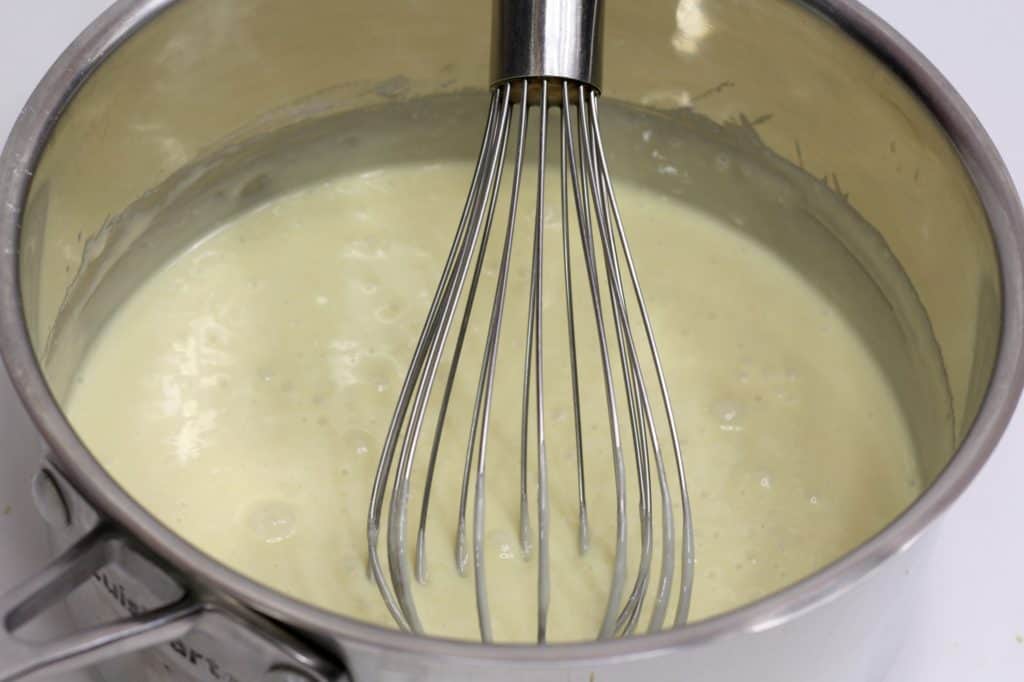 whisk stirring saucepan with cake mix and sweetened condensed milk