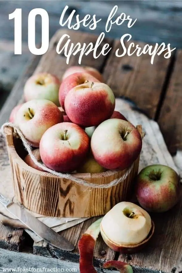 bucket of apples on a wooden cutting board with a knife