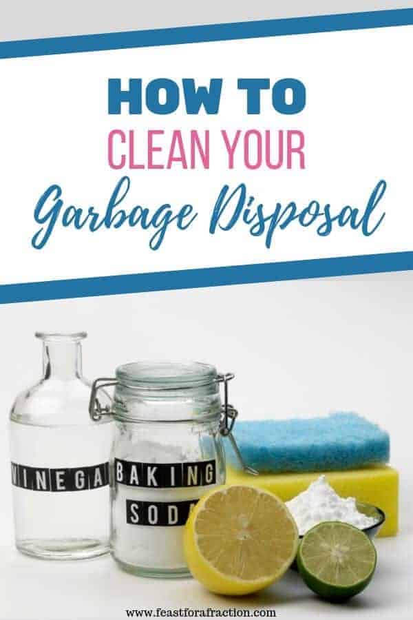 jars of vinegar and baking soda on a counter with a sponge and lemon cut in half