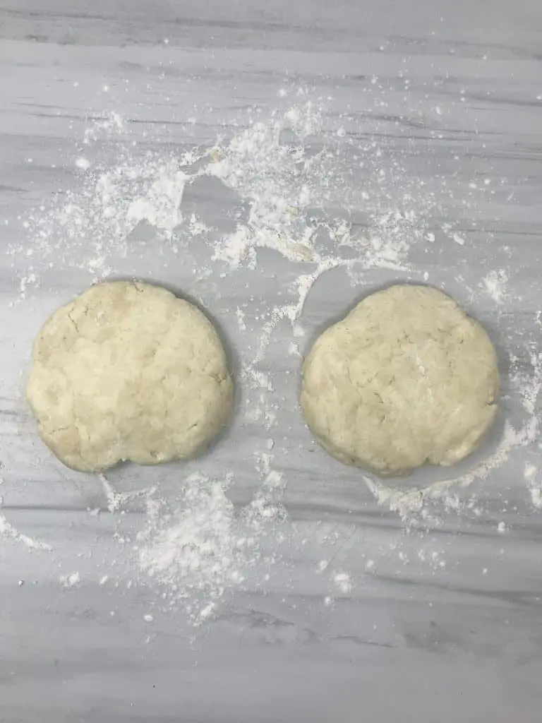 two pieces of cream cheese dough on marble counter