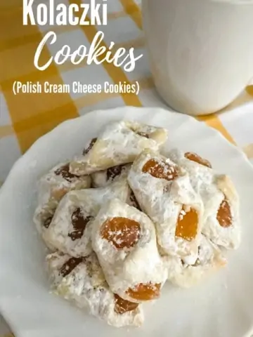 apricot kolaczki cookies on white plate on yellow and white towel
