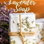 lavender soap wrapped with twine on wood counter with fresh lavender