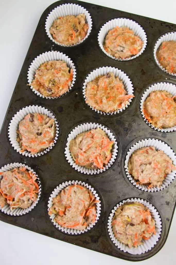 morning glory muffin batter portioned in muffin pan