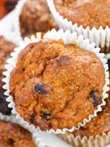 close up view of morning glory muffins stacked on white platter