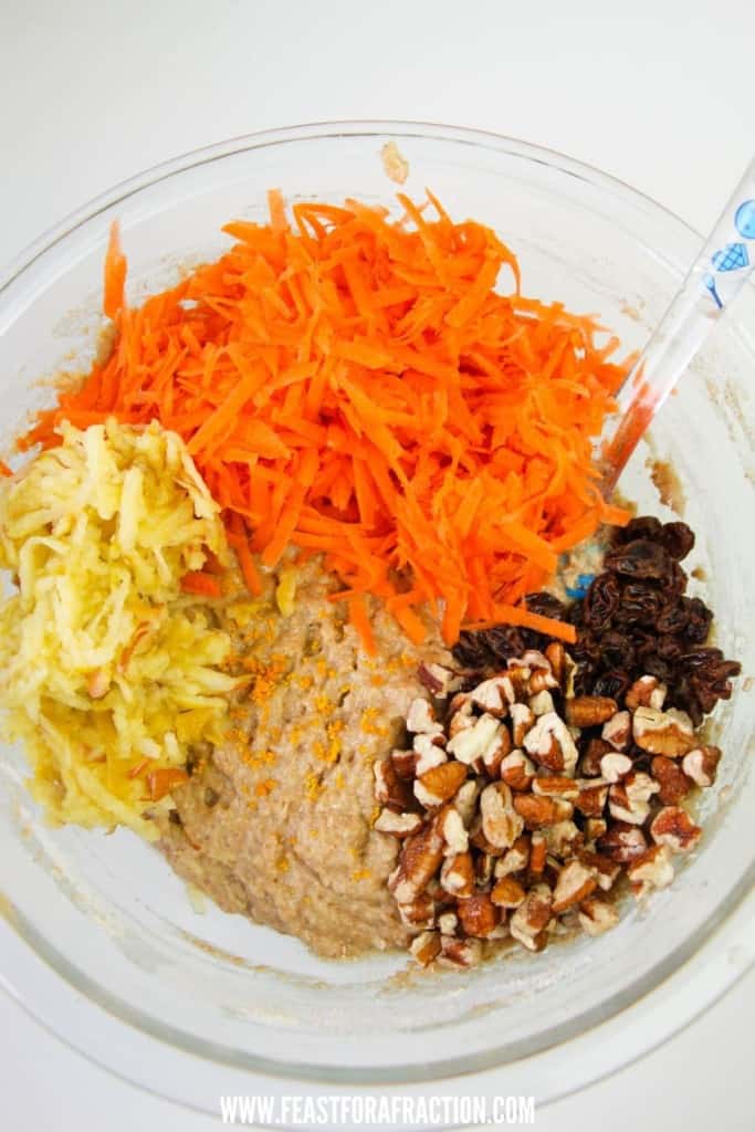 shredded apple, carrot, chopped pecans, raisins in bowl with muffin batter