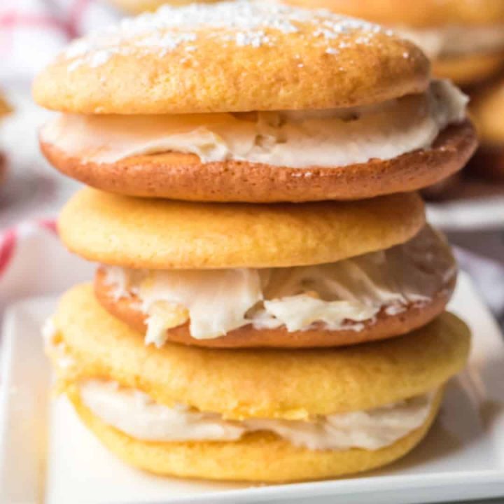 pineapple cream cheese cake mix whoopie pies stacked on white square plate