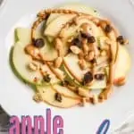sliced apples with peanut butter and chocolate on white plate with title text "apple nachos"