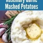 bowl of instant pot mashed potatoes with garlic cloves and rosemary sprig on wooden cutting board with title text "Instant Pot Rosemary Garlic Mashed Potatoes)
