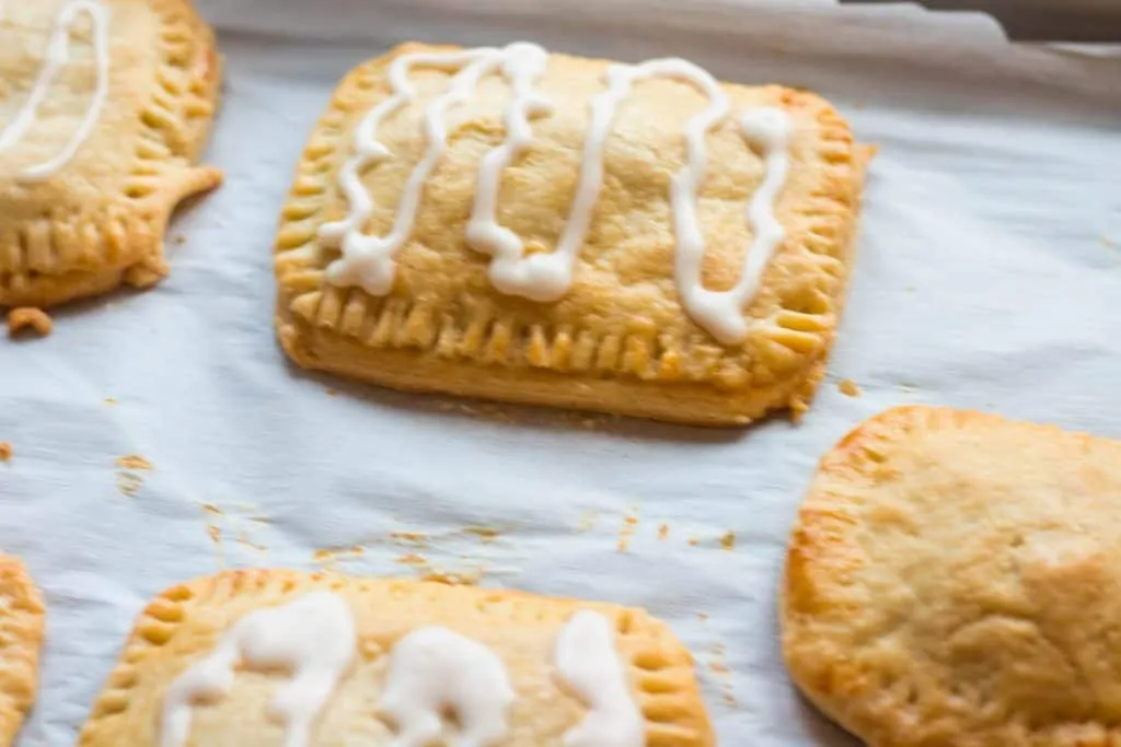 baked toaster pastries on baking sheet with glaze