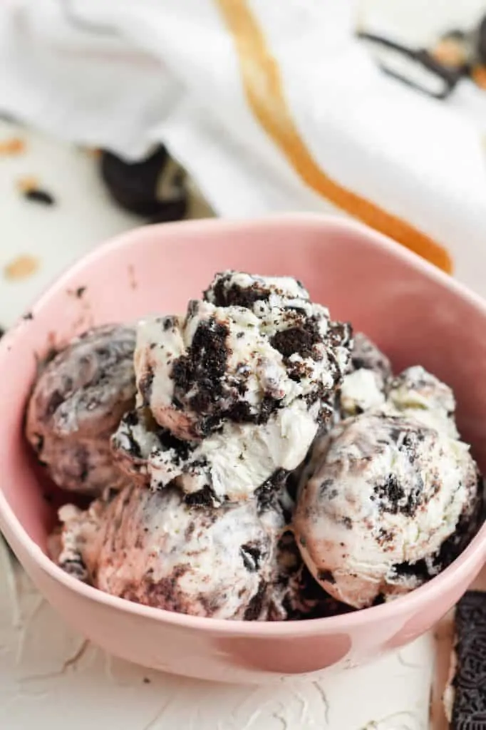 overhead view of no church cookies and cream ice cream in pink bowl with white towel in background