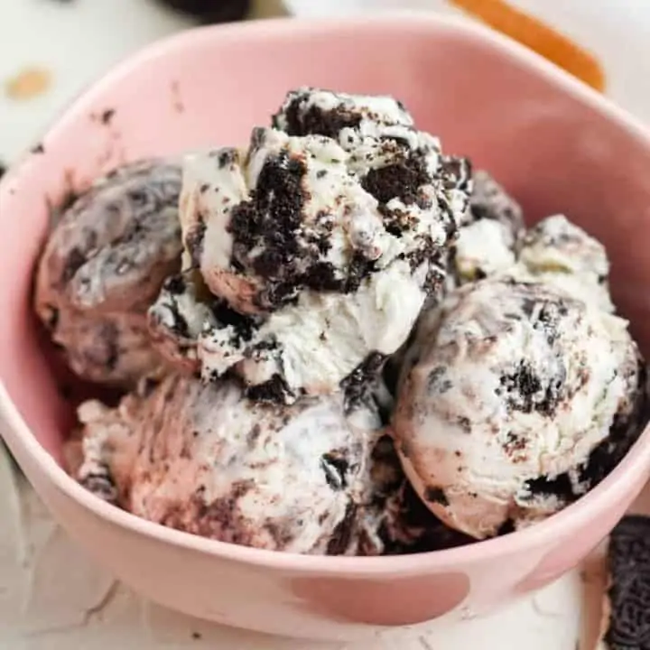 square image of pink bowl filled with cookies and cream ice cream