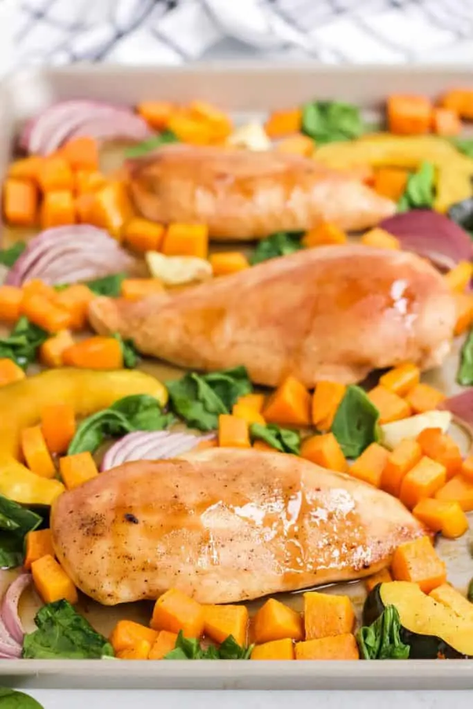 maple mustard chicken breast and roasted vegetables on sheet pan