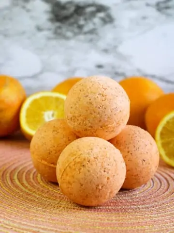 diy bath bombs on orange placemat with orange slices