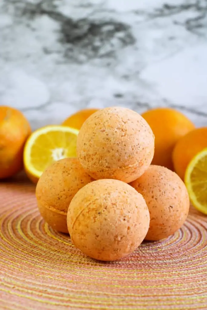 diy bath bombs on orange placemat with orange slices