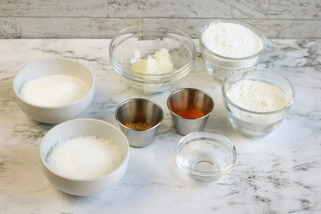 diy bath bomb ingredients measured into containers on counter