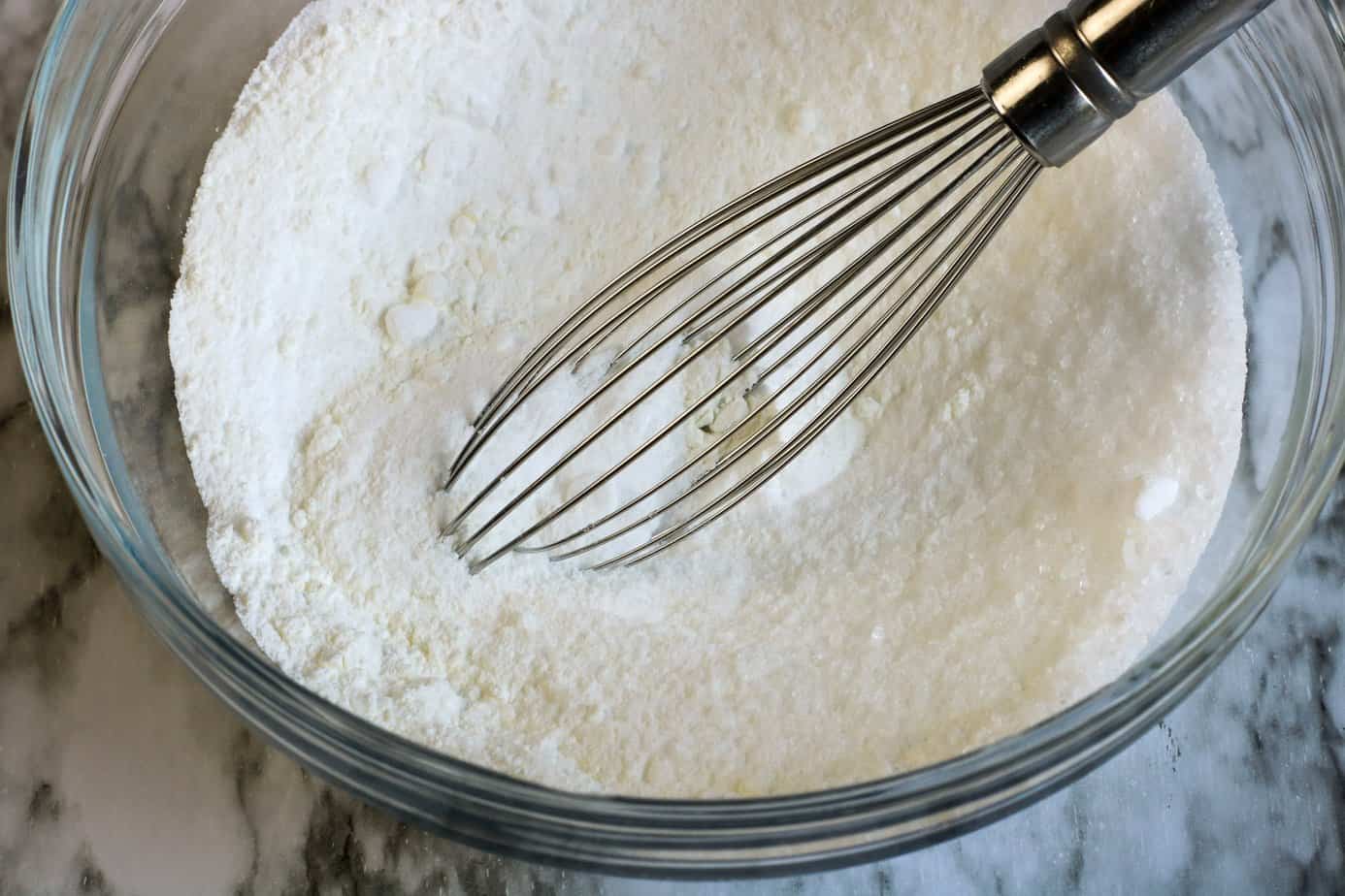 corn starch, epsom salt, and baking powder in glass bowl with whisk