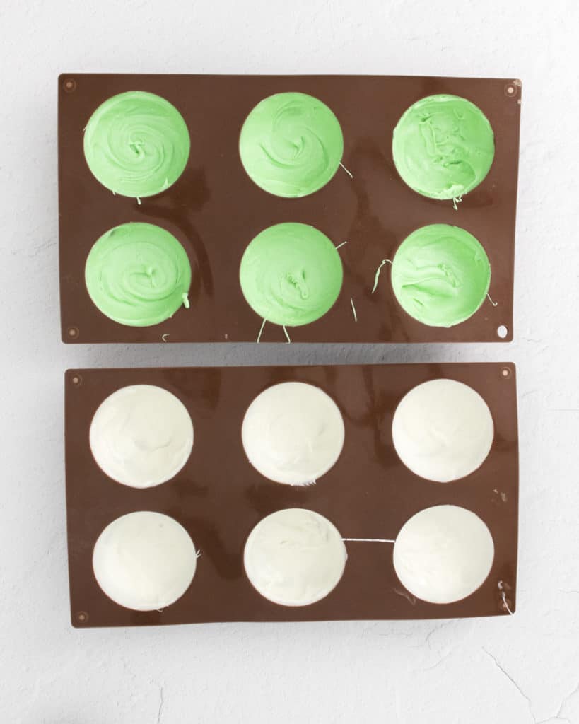 green and white candy melts in hot chocolate bomb molds