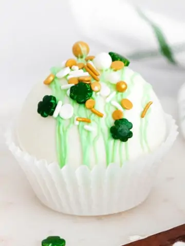 hot chocolate bomb with shamrock sprinkles and green chocolate decorations