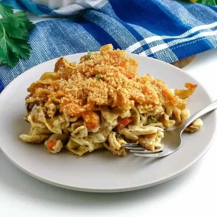 baked tuna noodle casserole on white plate with fork