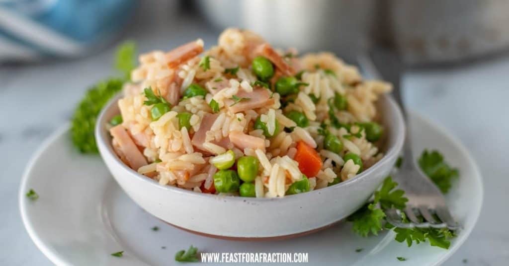 teriyaki ham stir fry in white bowl with parsley garnish