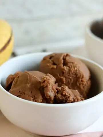 bowl of chocolate peanut butter nice cream (vegan ice cream) in white bowl