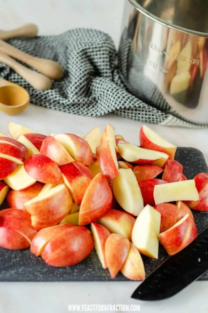 sliced apples on cutting board with instant pot liner in background
