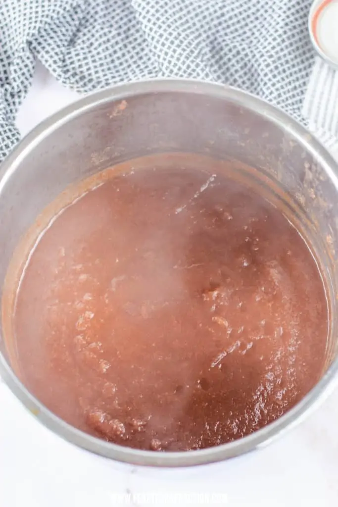 overhead view of instant pot apple butter simmering in instant pot liner