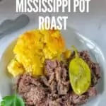 shredded mississippi roast on white plate with title text "Crockpot Mississippi Pot Roast"