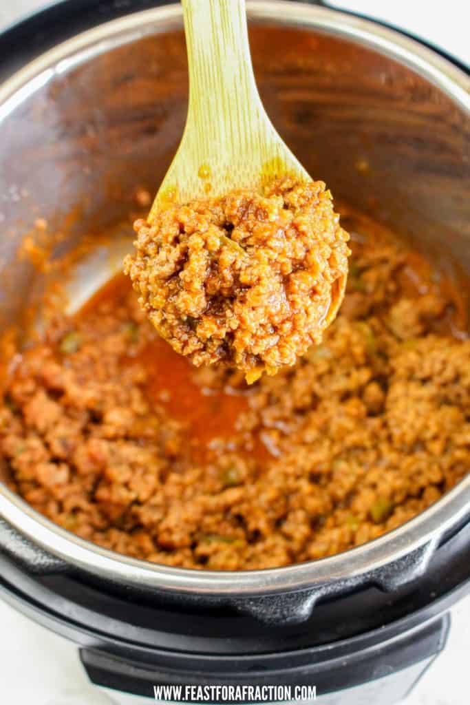 cooked sloppy joes meat in instant pot with wooden spoon