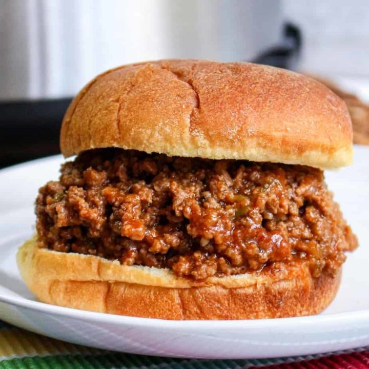 close up of sloppy joes sandwich on white plate