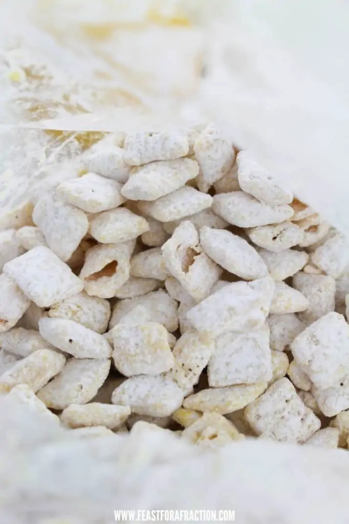 prepared lemon puppy chow in freezer bag with powdered sugar