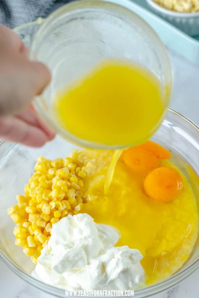melted butter poured into bowl with corn, eggs, sour cream and corn muffin mix