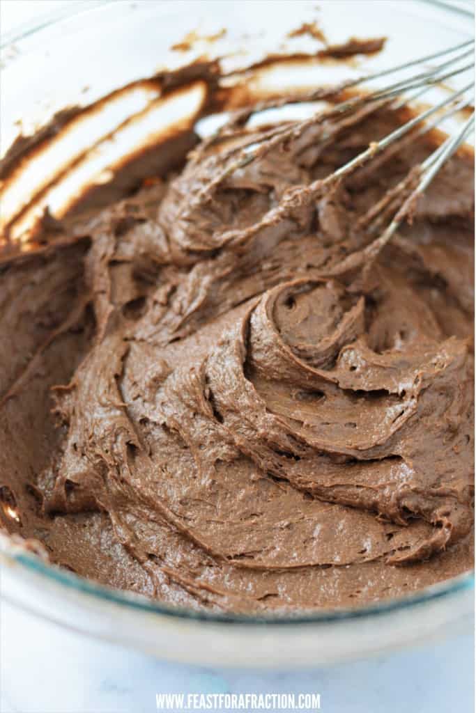 chocolate pumpkin muffin batter in mixing bowl with whisk