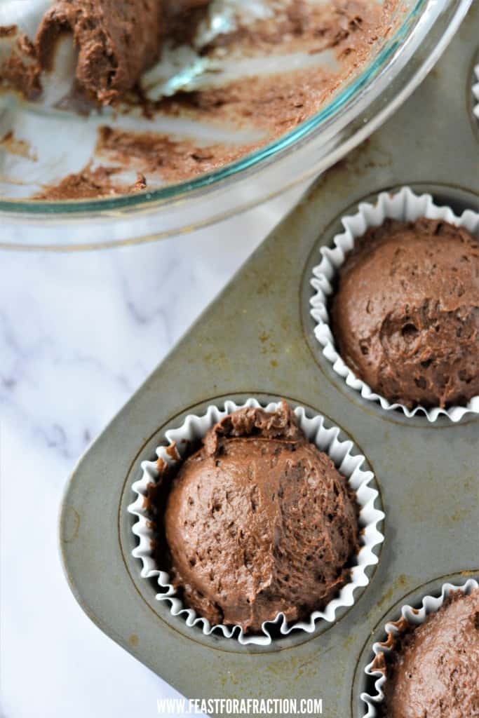 chocolate pumpkin muffin batter in cupcake liners in muffin pan