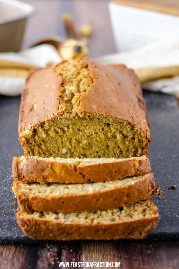 sliced applesauce banana bread on slate cutting board