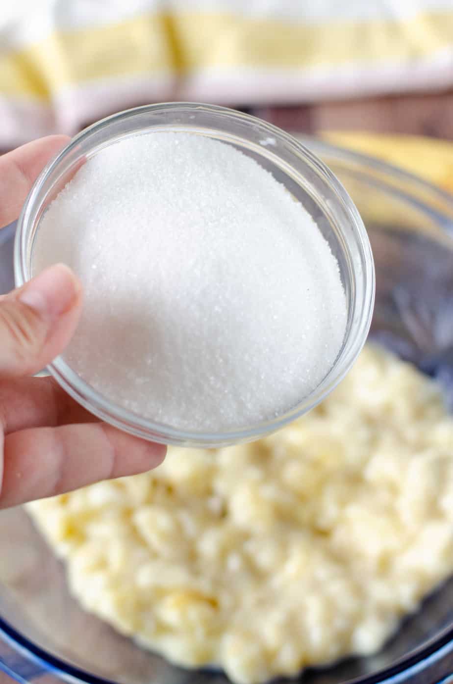 sugar being added to mashed bananas