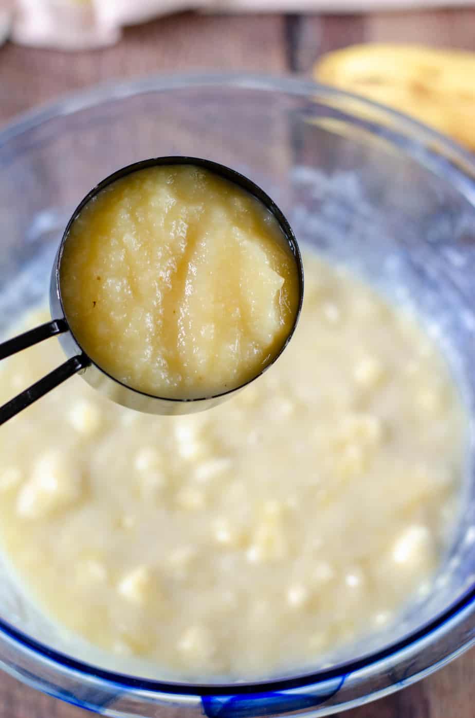 applesauce being added to applesauce banana bread wet ingredients