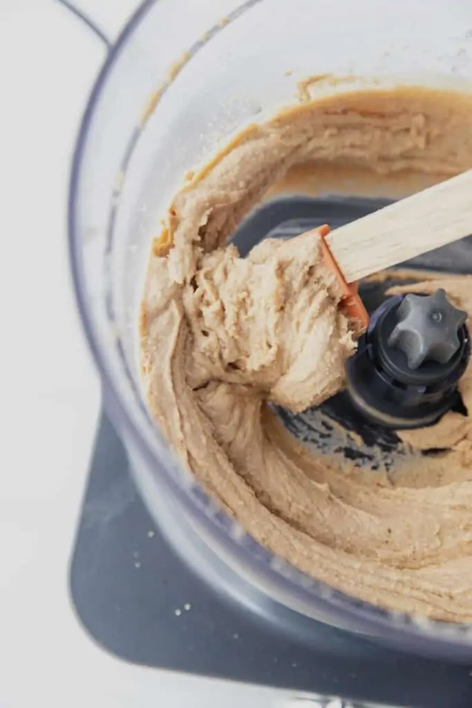blended cashew butter in food processor with spatula