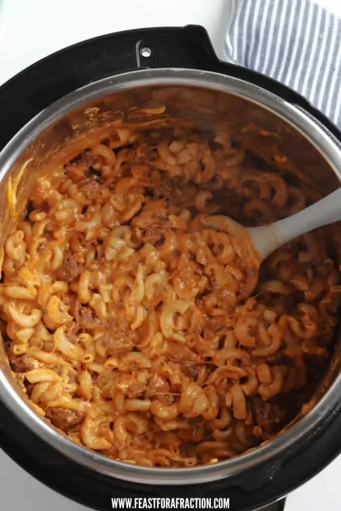 overhead view of homemade hamburger helper in instant pot with large spoon