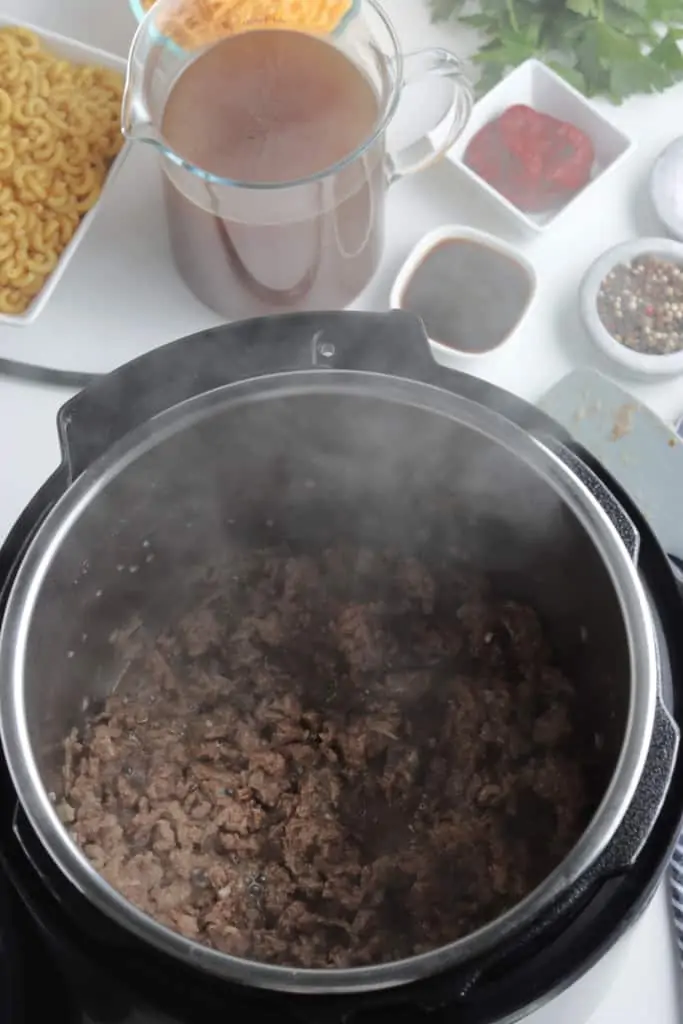 ground beef and onions sauteing in instant pot