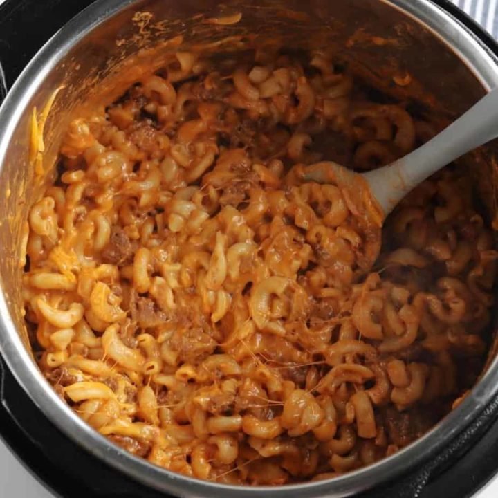 cheesy homemade hamburger helper in instant pot with mixing spoon