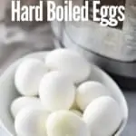 hard boiled eggs in a white bowl with instant pot in the background with title text "Instant Pot Hard Boiled Eggs"