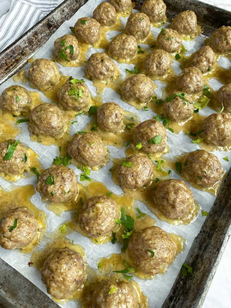 cooked baked meatballs on sheet pan