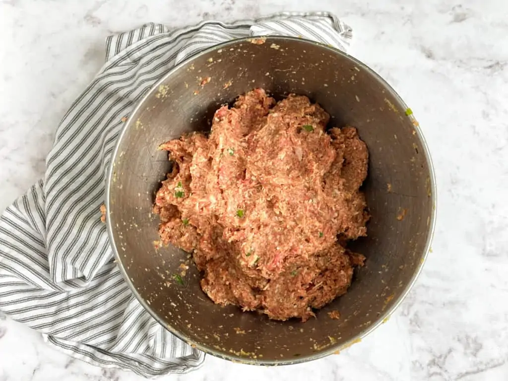 ingredients for baked meatballs in mixing bowl combined