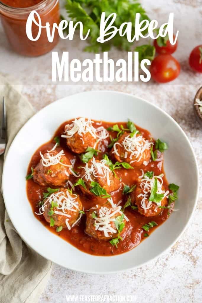 prepared baked meatballs in white bowl with tomato sauce parmesan cheese and chopped parsley with title text "Oven Baked Meatballs"