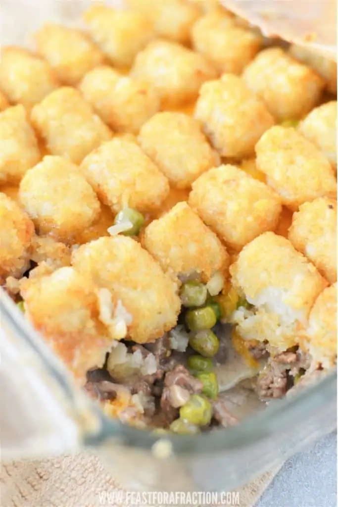 close up of tater tot casserole with ground beef and peas filling