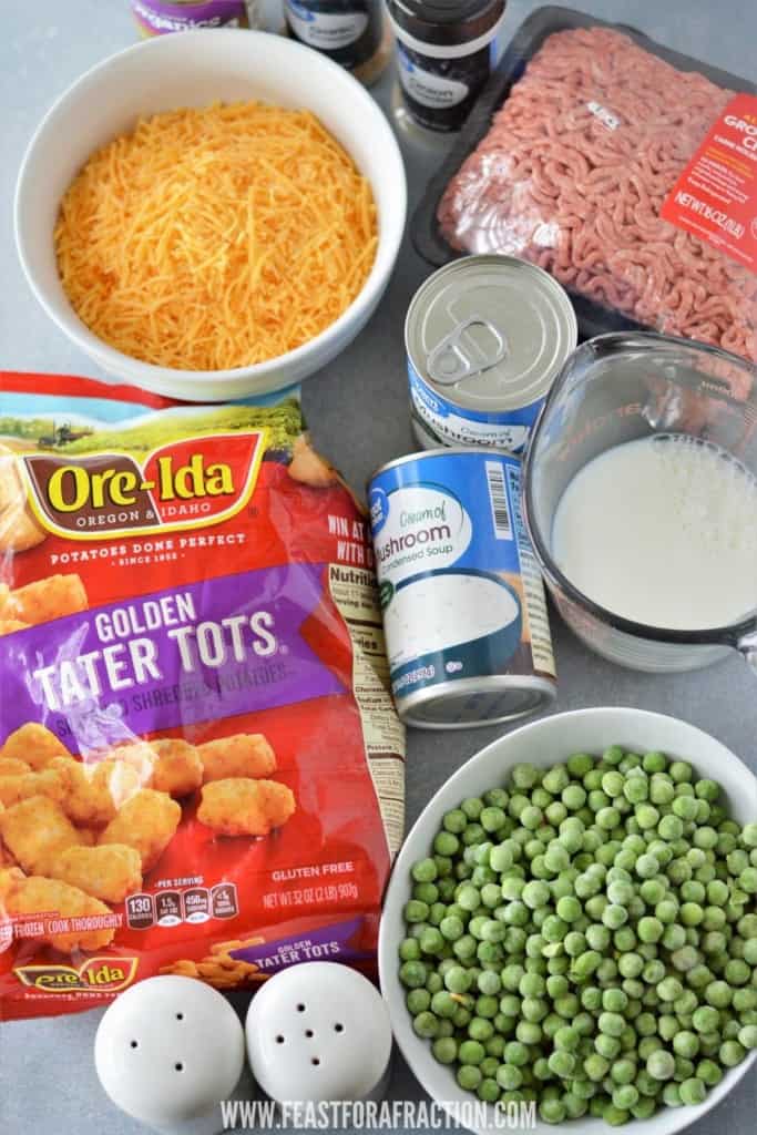 ingredients for tater tot casserole: ground beef, shredded cheese, tater tots, cream of mushroom soup, milk, frozen peas, salt and pepper